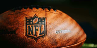 Close-up of an NFL football on grass.