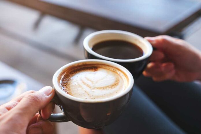 Closeup,Image,Of,A,Man,And,A,Woman,Clinking,Coffee Coffee cup on table in cafe interior