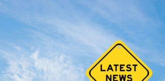 Yellow sign with text Latest News on sky background