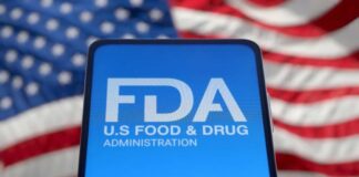 FDA logo displayed on a smartphone with an American flag background