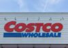 Costco Wholesale store sign against a blue sky