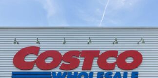 Costco Wholesale store sign against a blue sky