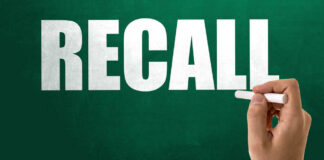 Recall notice over grocery store shelves.
