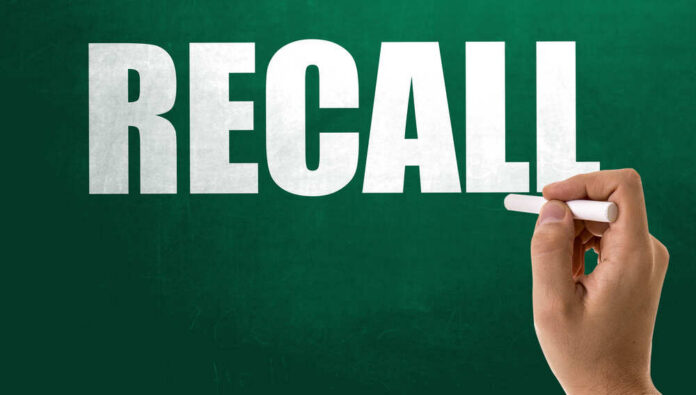Recall notice over grocery store shelves.