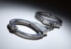 NOW: Airport Dragnets Snare THESE Foreigners Close-up of metallic handcuffs on a light surface