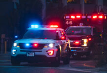 Police car and ambulance with flashing lights nighttime