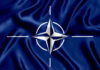 Patriot Drought Sparks NATO Worries?! NATO flag with white compass emblem on blue background.