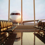 Airplane viewed from an empty airport waiting area.