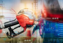 Gas pump with financial data overlay and oil refinery in the background