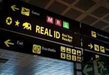 Airport sign displaying directions and information about Real ID