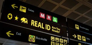 Airport sign displaying directions and information about Real ID