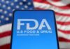 FDA logo displayed on a smartphone with an American flag background