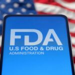 FDA Flags Walmart Food Item — Toss It FDA logo displayed on a smartphone with an American flag background