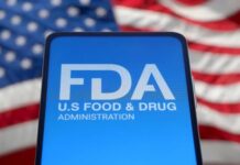 FDA logo displayed on a smartphone with an American flag background
