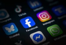 Close-up of various social media application icons on a smartphone screen