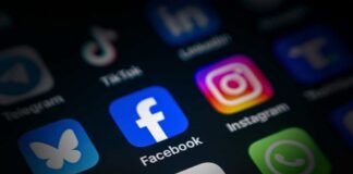 Close-up of various social media application icons on a smartphone screen