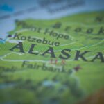 Map of Alaska with a small American flag