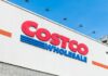 Costco Wholesale store sign against a blue sky