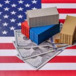 Mini shipping containers on US dollars over an American flag