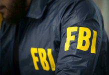 FBI agent in navy blue jacket.