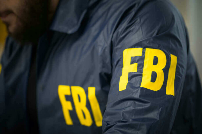 FBI agent in navy blue jacket.