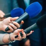 Costco’s Monster Head Sparks Buying Frenzy Reporters holding colorful microphones