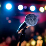 Microphone with colorful stage lights in the background.
