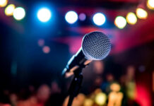 Microphone with colorful stage lights in the background.