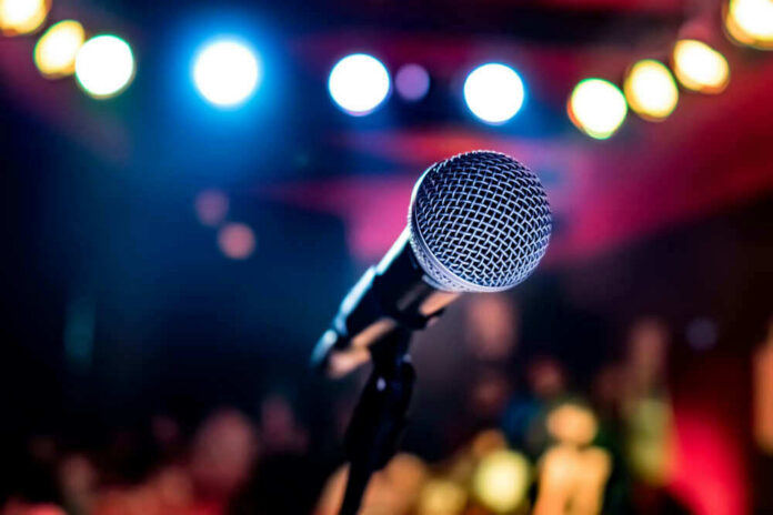 Microphone with colorful stage lights in the background.
