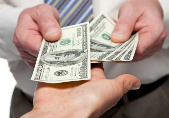 Human,Hands,Exchanging,Money,-,Closeup,Shot Two hands exchanging cash bills
