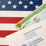 Trump’s Refugee Shake-Up Favors THIS Group Permanent resident card and official letter on an American flag background