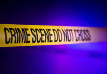 Yellow crime scene tape with the words 'CRIME SCENE DO NOT CROSS'