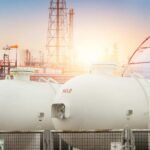 Gas storage tanks in an industrial facility during sunrise
