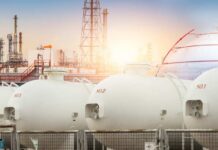 Gas storage tanks in an industrial facility during sunrise