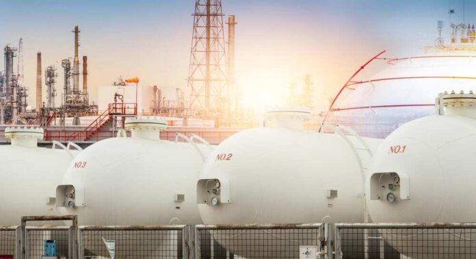 Gas storage tanks in an industrial facility during sunrise