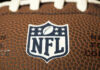 Crime Bombshell Snags NFL Star Close-up of NFL logo on American football.
