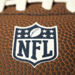 Close-up of NFL logo on American football.