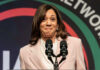 Kamala Harris speaking at a podium with two microphones