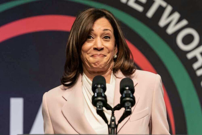 Kamala Harris speaking at a podium with two microphones