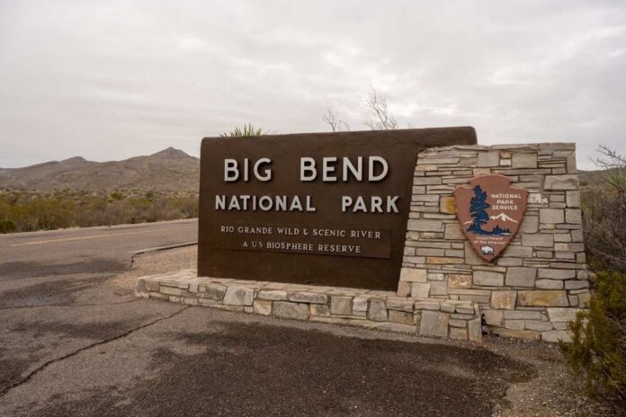 Big Bend National Park entrance sign with stone base in desert landscape