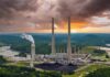 Coal-fired power plant with tall smokestacks at sunset