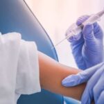 A healthcare professional administering a vaccine to a child's arm