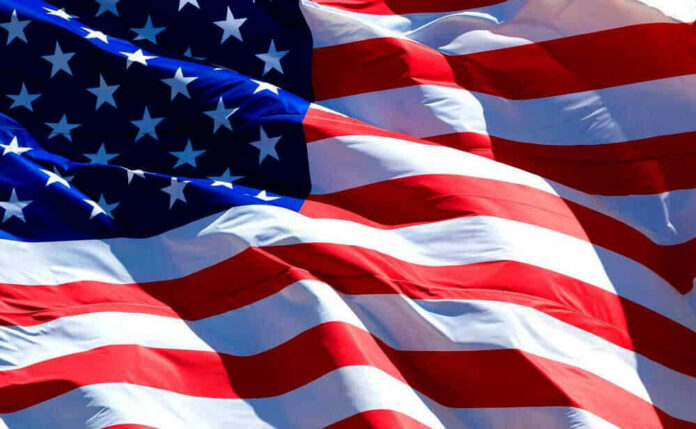 shutterstock_267522383-1 USA flag waving in the wind.