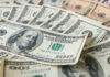Stacks of various U.S. dollar bills.