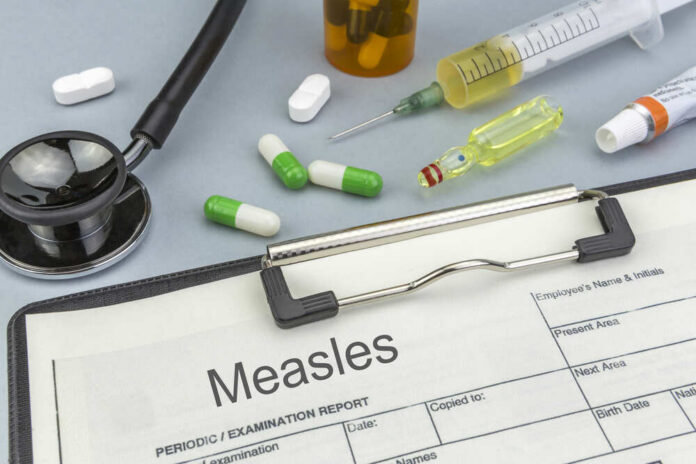 Measles,,Medicines,And,Syringes,As,Concept,Of,Ordinary,Treatment,Health Medical supplies including a stethoscope, syringes, and medication related to measles