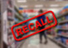 Recall stamp on blurred store aisle background.