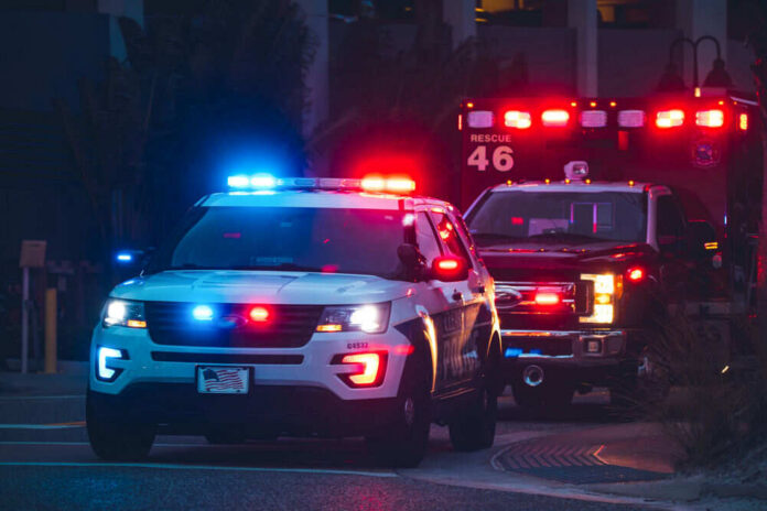 Police car and ambulance with flashing lights nighttime
