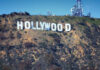 Hollywood sign on hillside with communication towers.