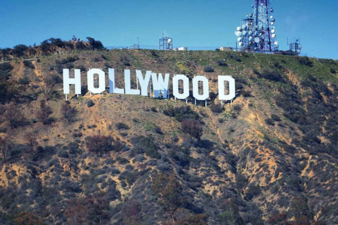 Hollywood sign on hillside with communication towers.