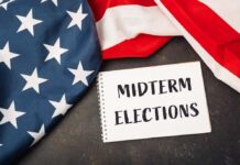 American flag and a notebook with 'MIDTERM ELECTIONS' written on it